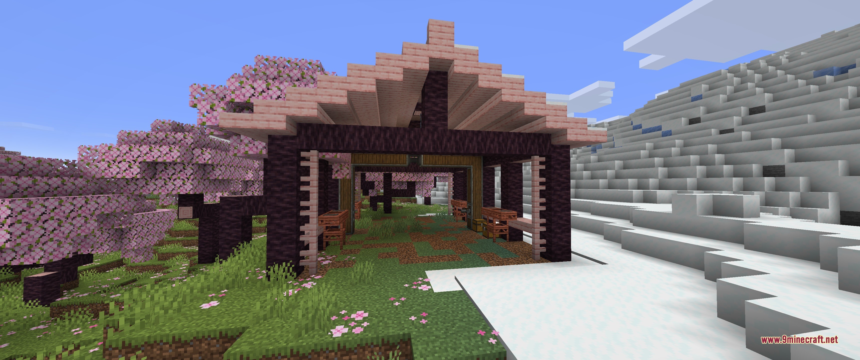 A large wooden hangar structure located in a cherry blossom biome