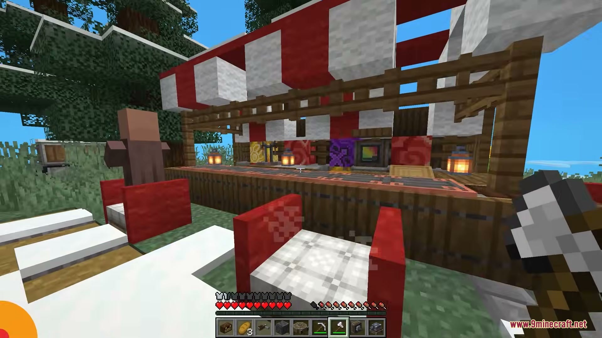 A villager works at a market stall with a red and white awning