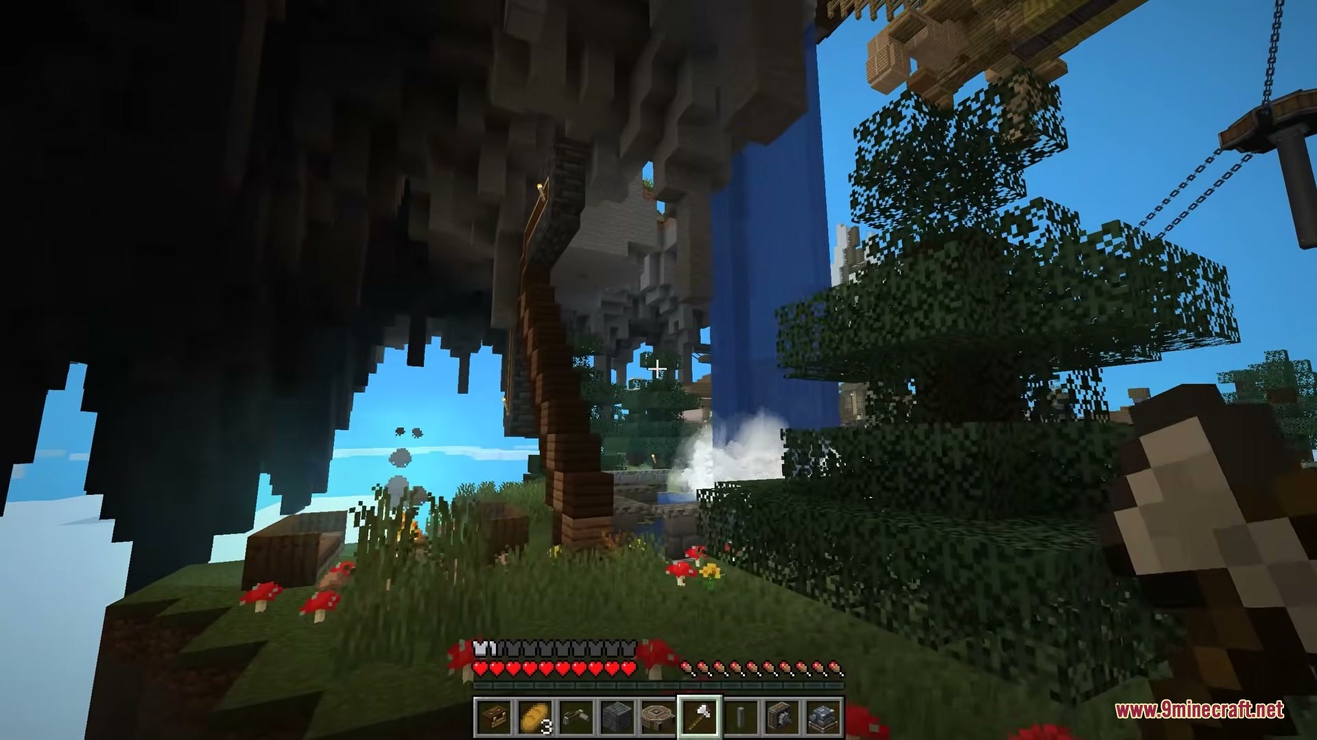 Player exploring the grassy underside of a floating island with wooden stairs