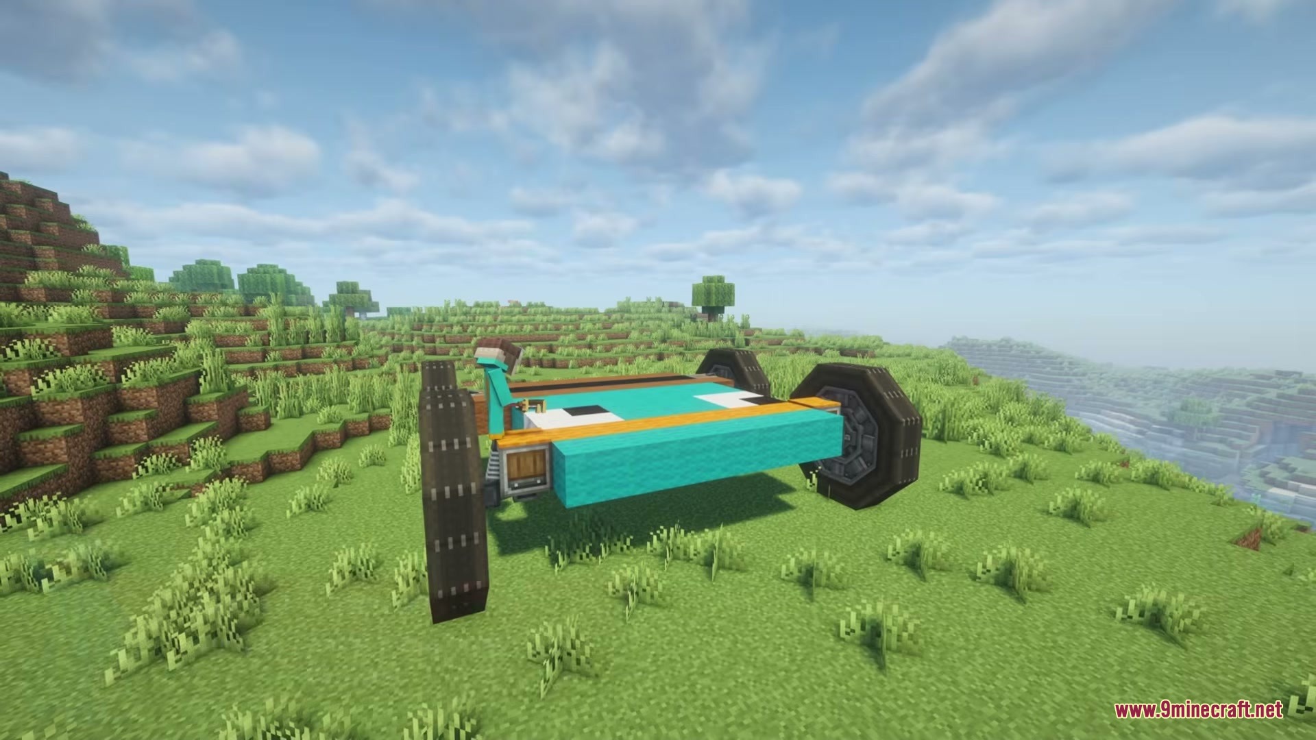 A custom platypus themed vehicle with large wheels parked on a grassy hill