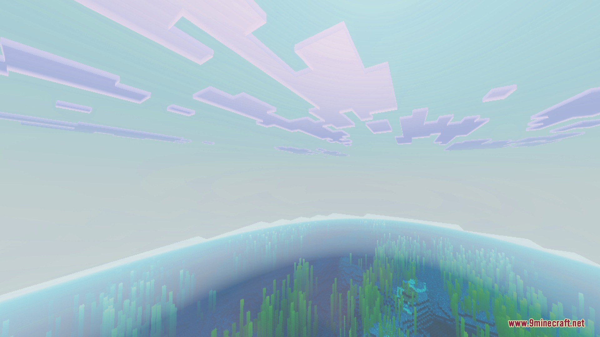 Vibrant pink clouds over a clear blue ocean with an underwater structure