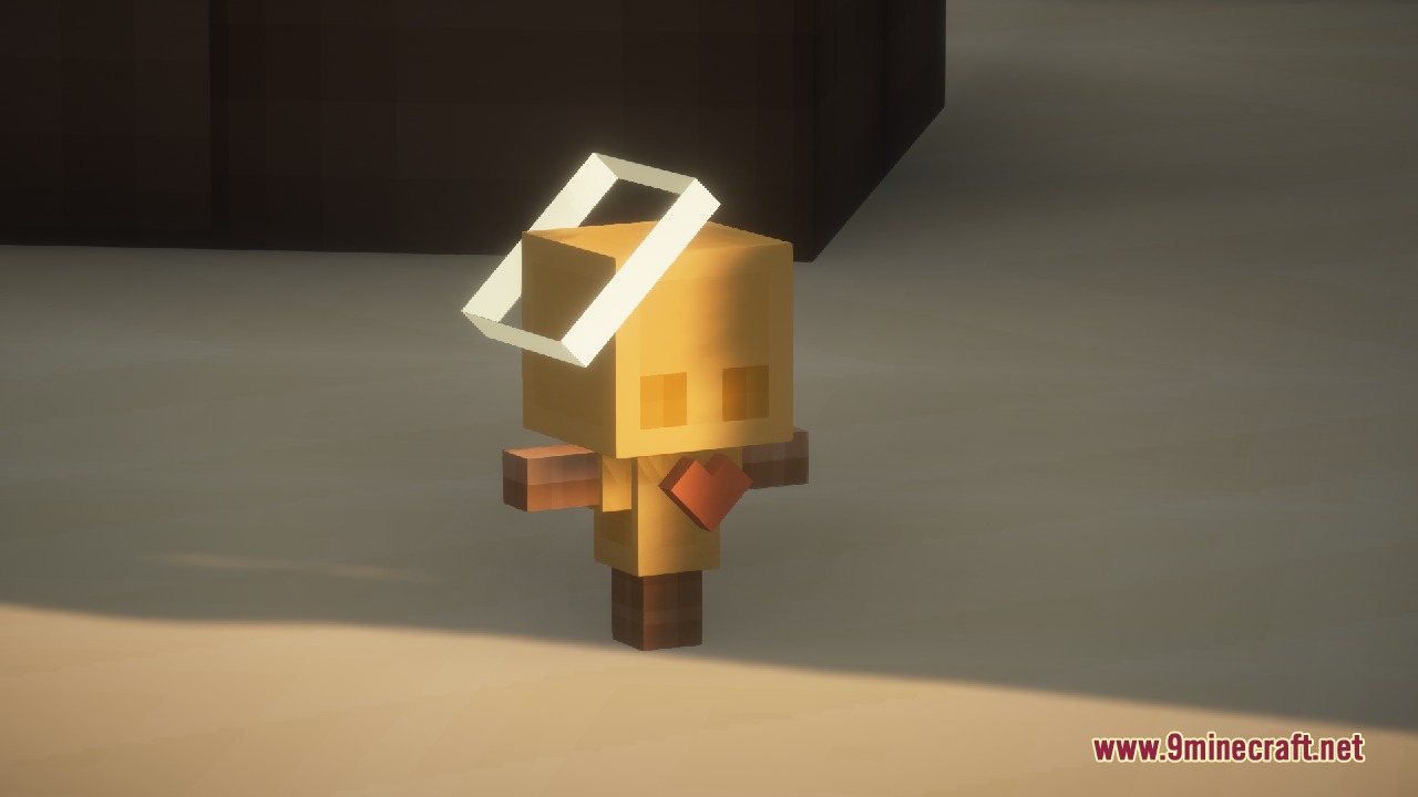A small golden totem figure with a halo and a red heart