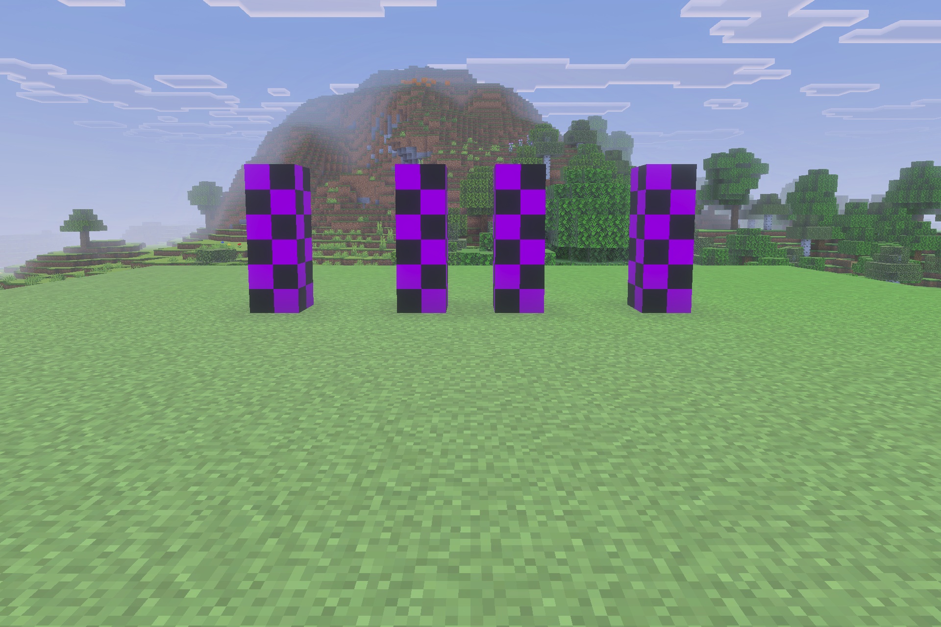 Decayed Reality V2.1 - Wither Storm Replica Addon Screenshot 5 Four pillars of purple and black checkered blocks in a grassy landscape