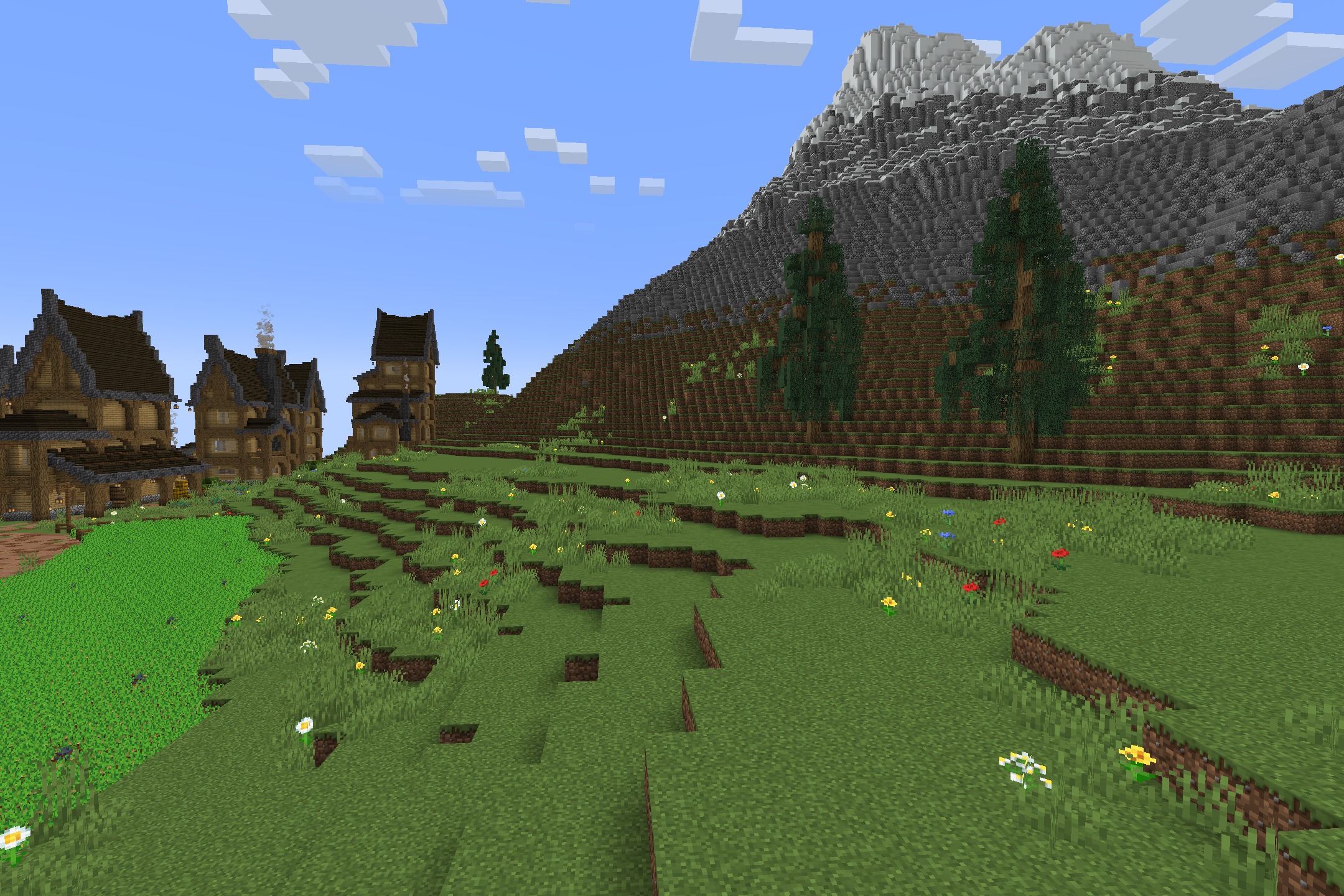 Default HD 512x Resource Pack Screenshot 4 Lush green landscape with flowers and wooden houses near a large mountain
