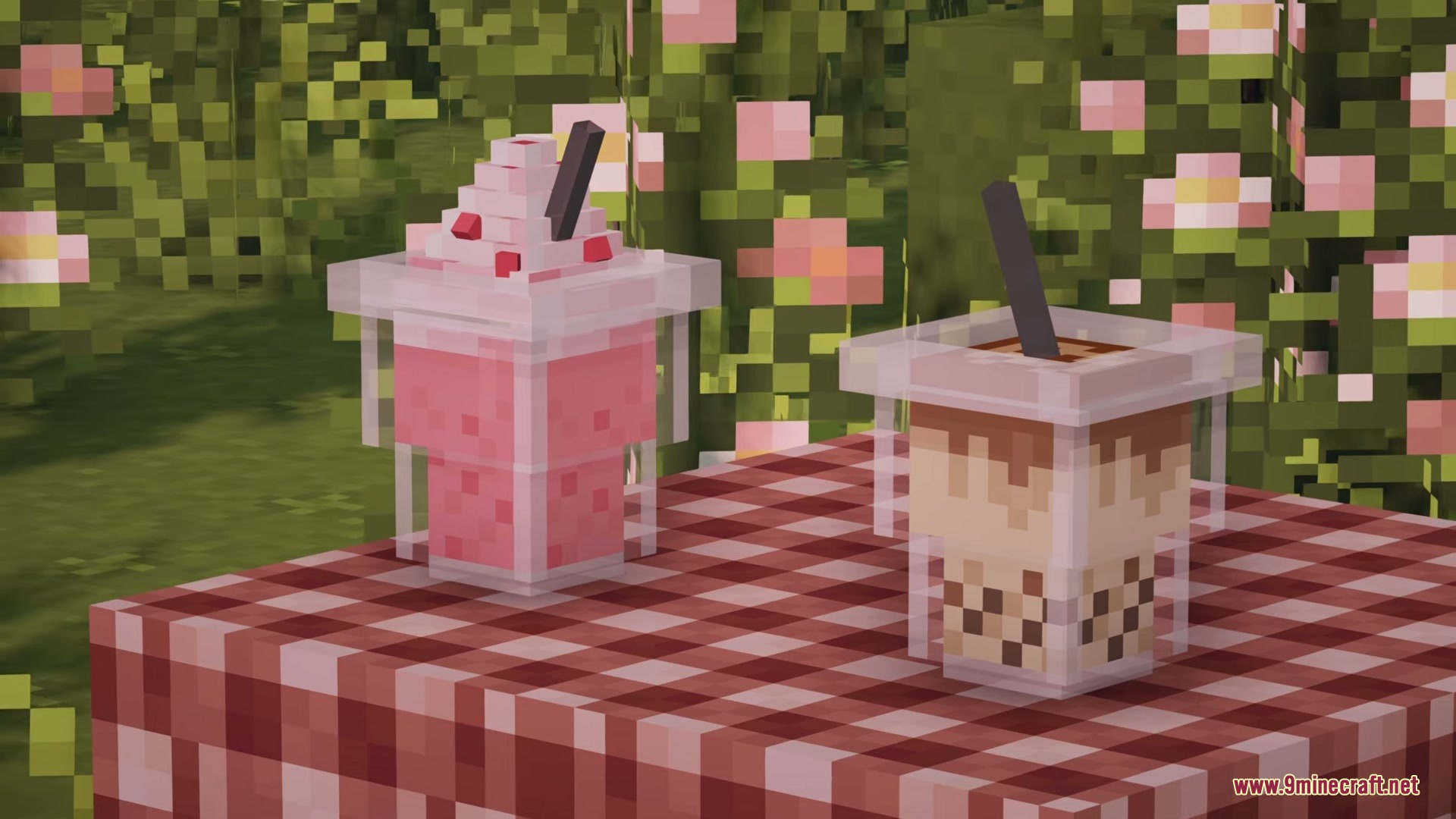 Pink milkshake and boba tea placed on a red checkered picnic table