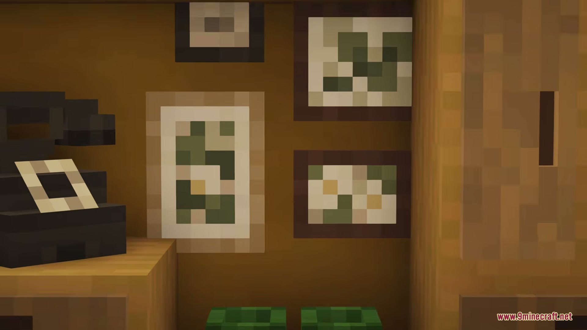 Close up view of several small framed paintings on a wooden wall