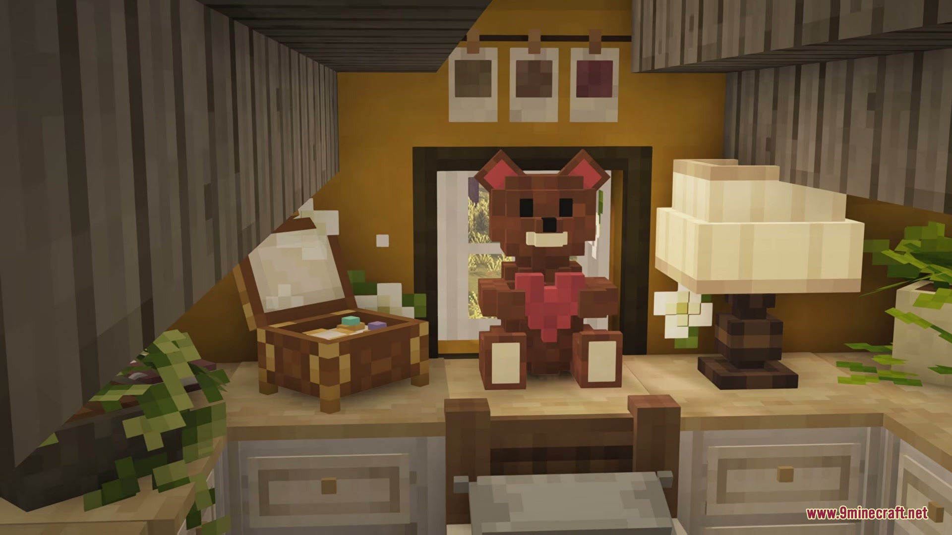 A cute brown teddy bear holding a red heart on a wooden desk