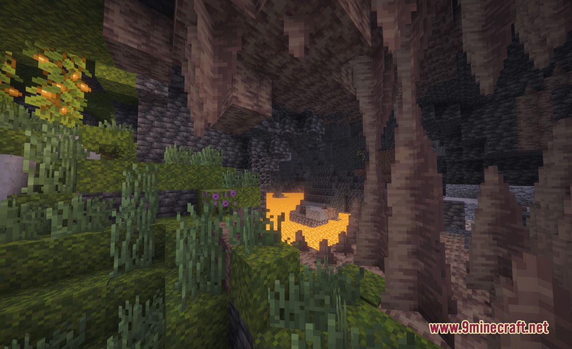 Lush cave biome featuring dripstone formations and glowing berries near lava