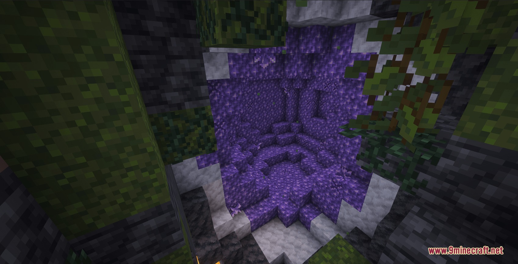 An amethyst geode filled with purple crystals hidden inside a dark cave