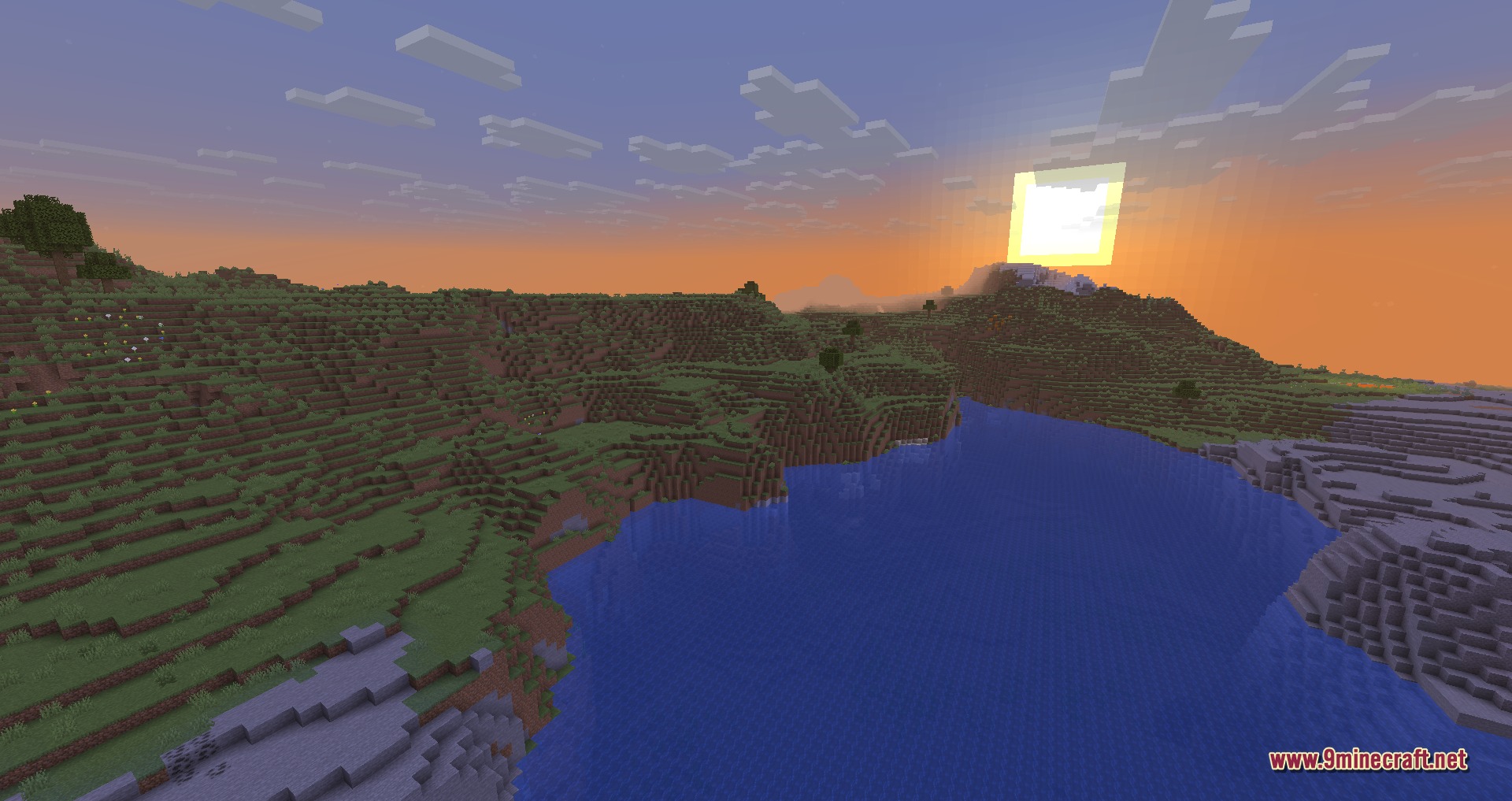 Disable Custom Worlds Advice 9minecraft Mod Screenshot 1 A scenic Minecraft landscape with rolling green hills and a lake at sunset
