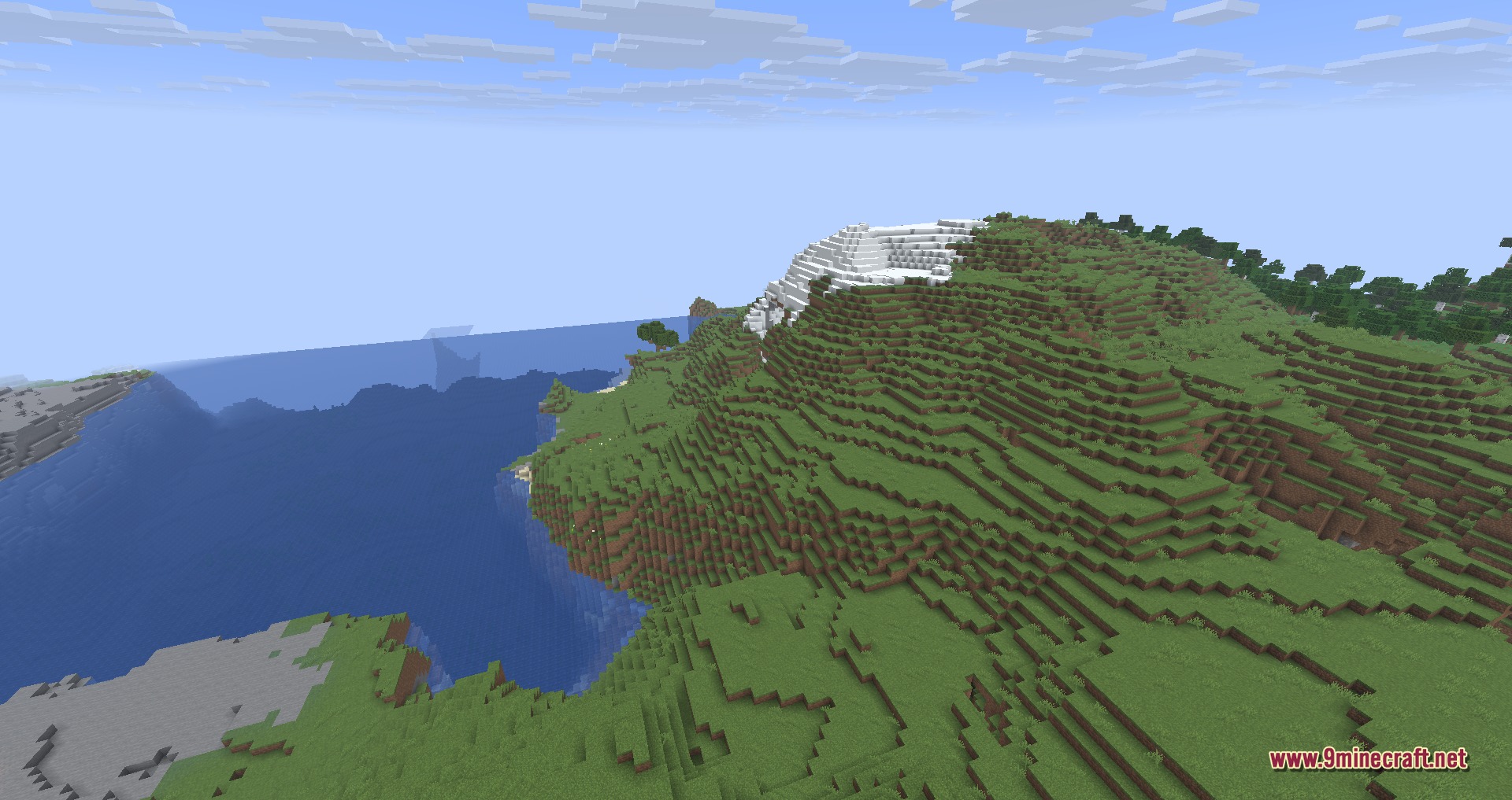 Disable Custom Worlds Advice 9minecraft Mod Screenshot 3 A vast Minecraft landscape featuring a grassy mountain with a snowy peak