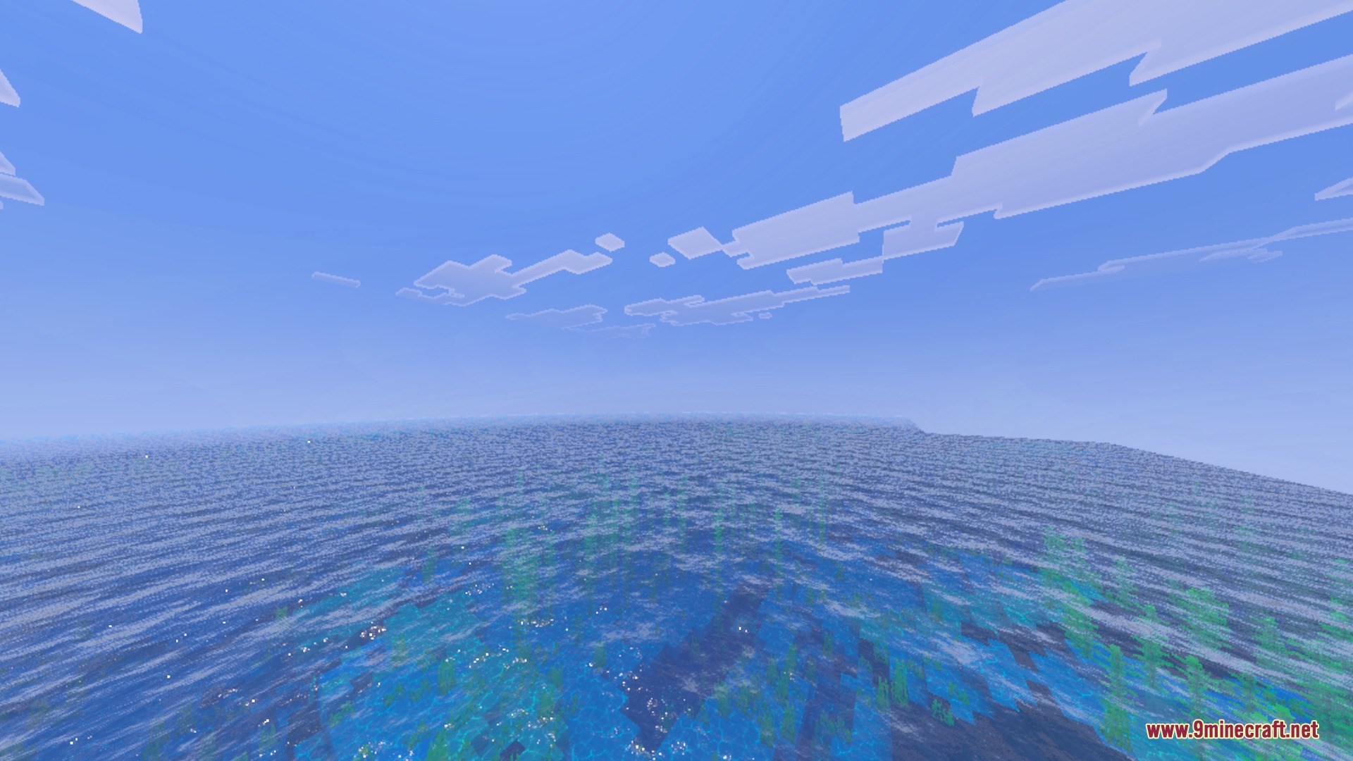 A vast blue ocean with realistic water effects under a clear sky
