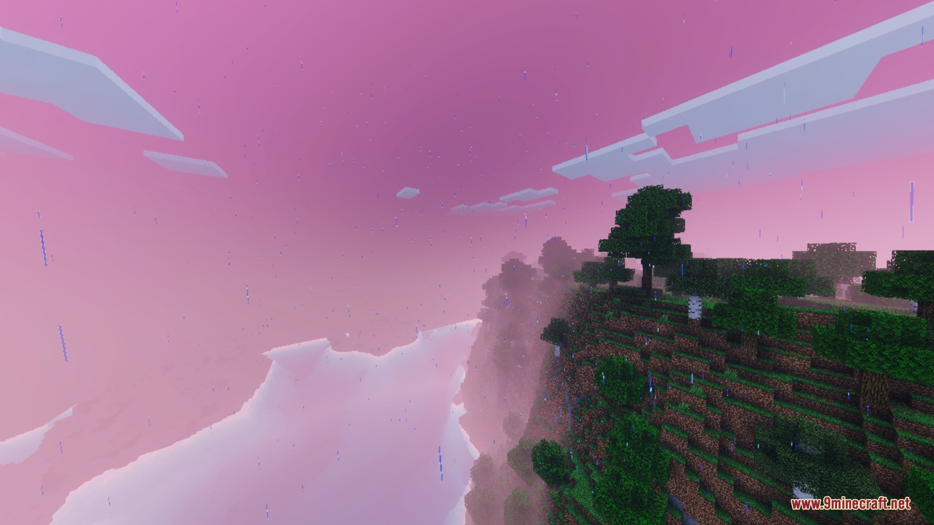 Rain falls over a lush green cliffside under a soft pink sky