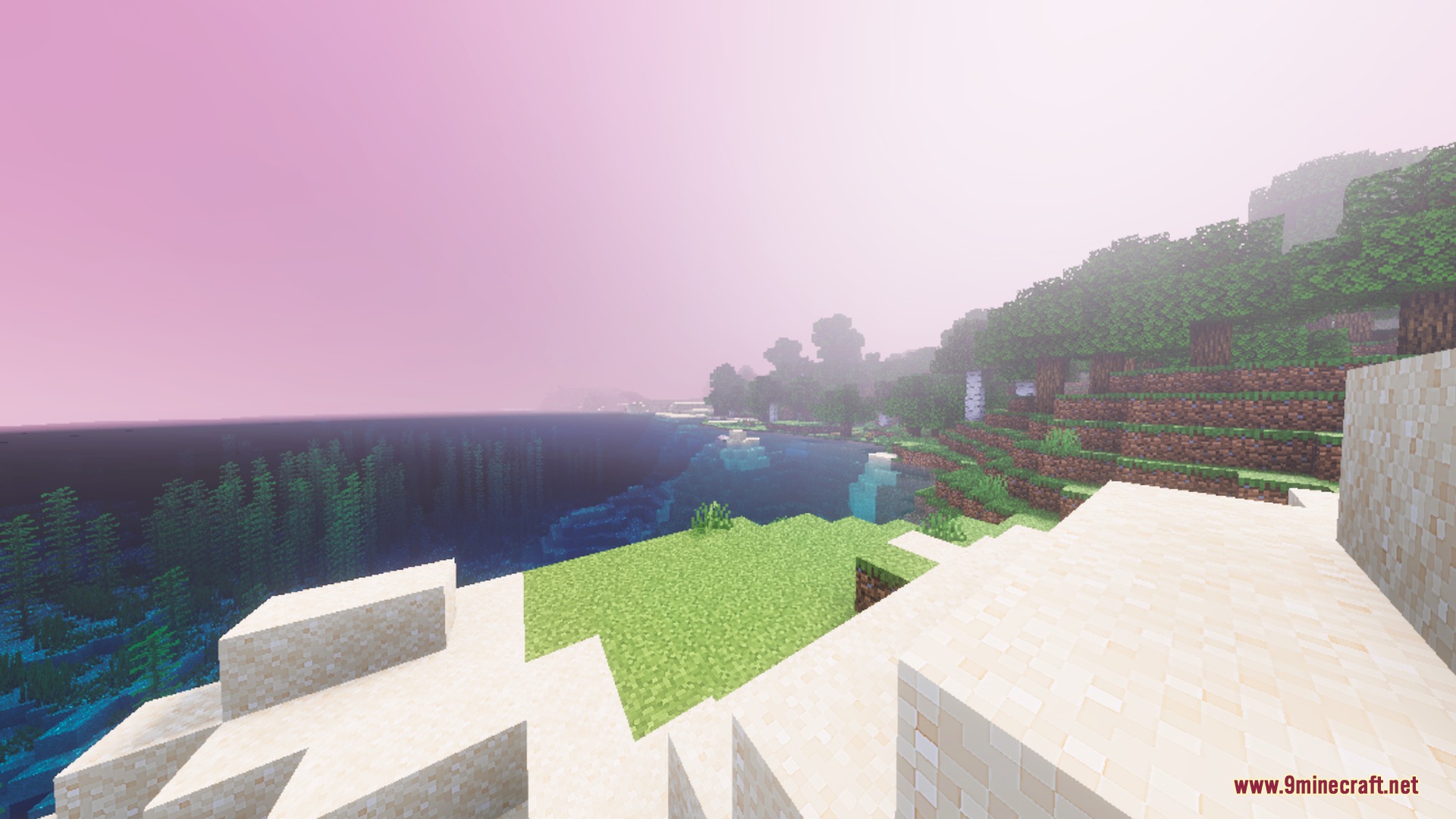 A bright coastal landscape with pink hazy skies and clear blue water