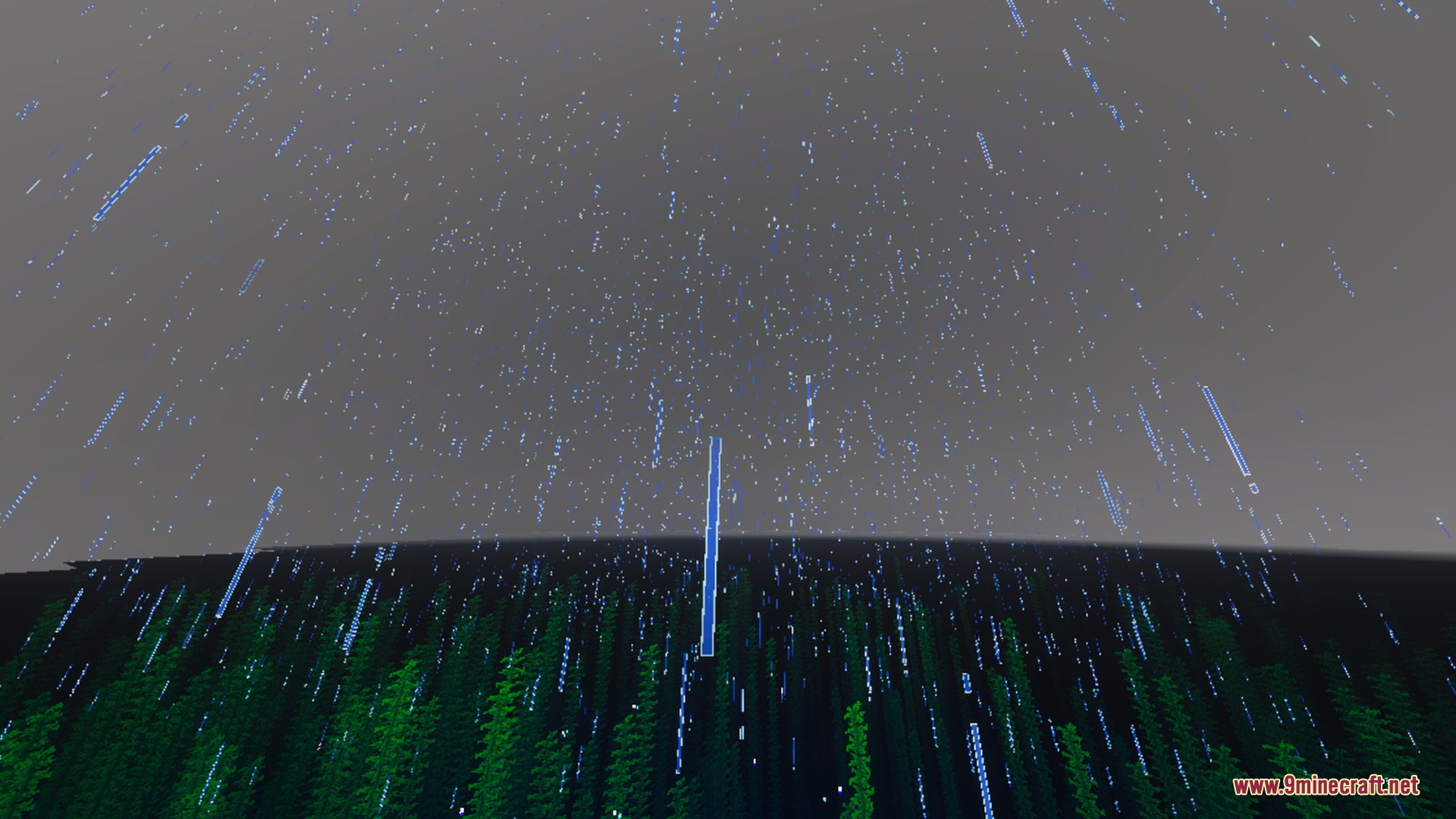 Heavy rain falling from a dark sky onto a dense green forest