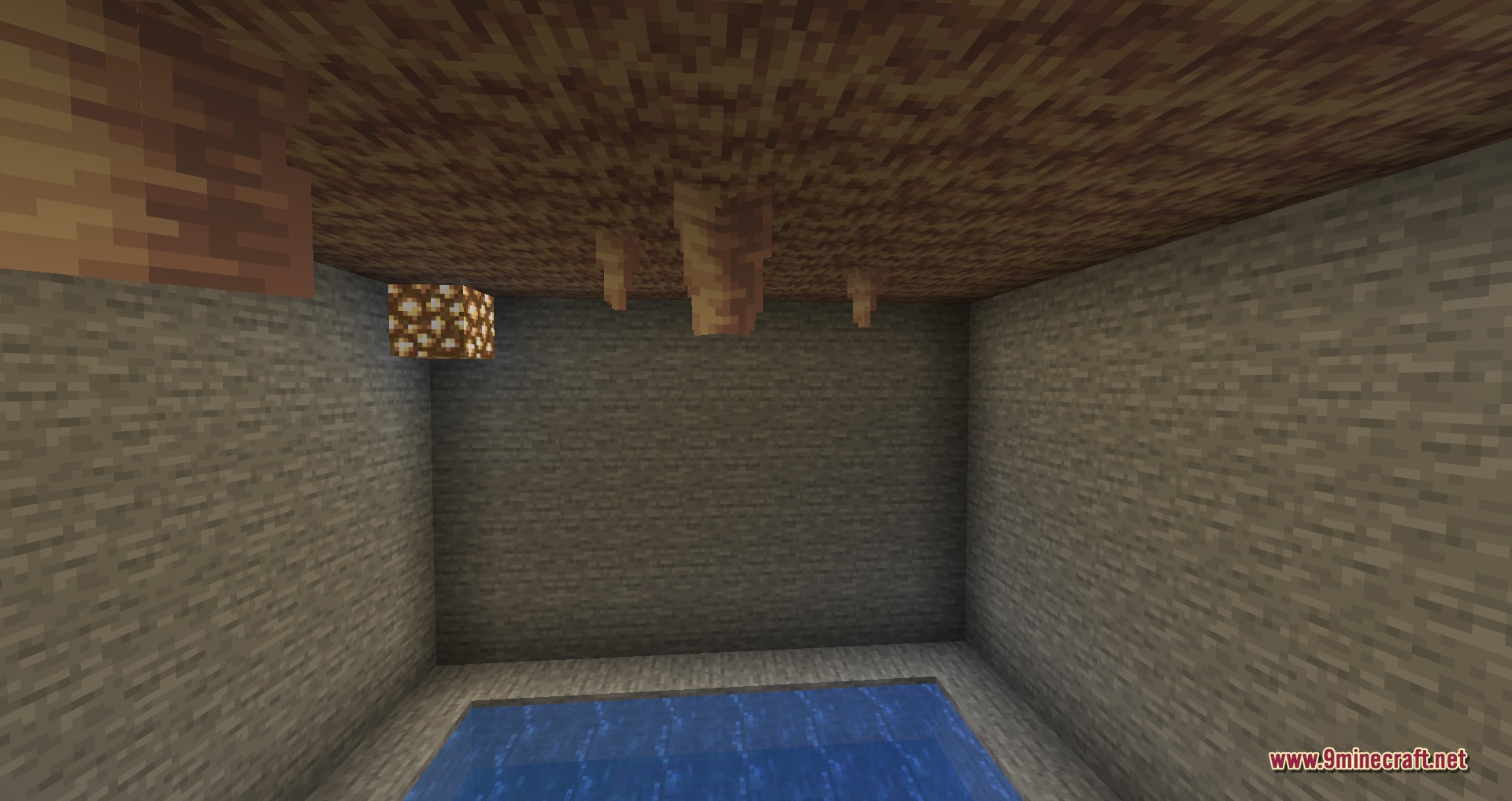 Pointed dripstone stalactites hanging over water to demonstrate the Drip Sounds mod