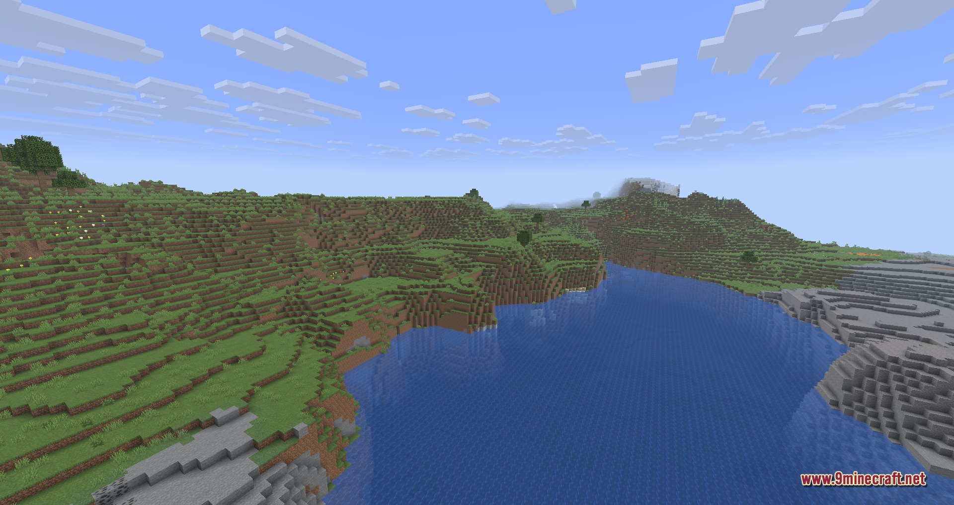 A wide river flowing through a scenic Minecraft landscape with green grassy hills