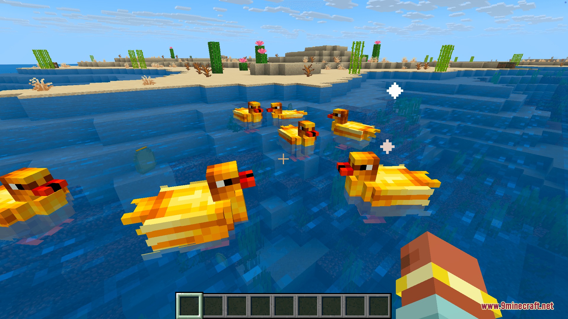 A flock of yellow ducks swimming in the ocean with leader crowns