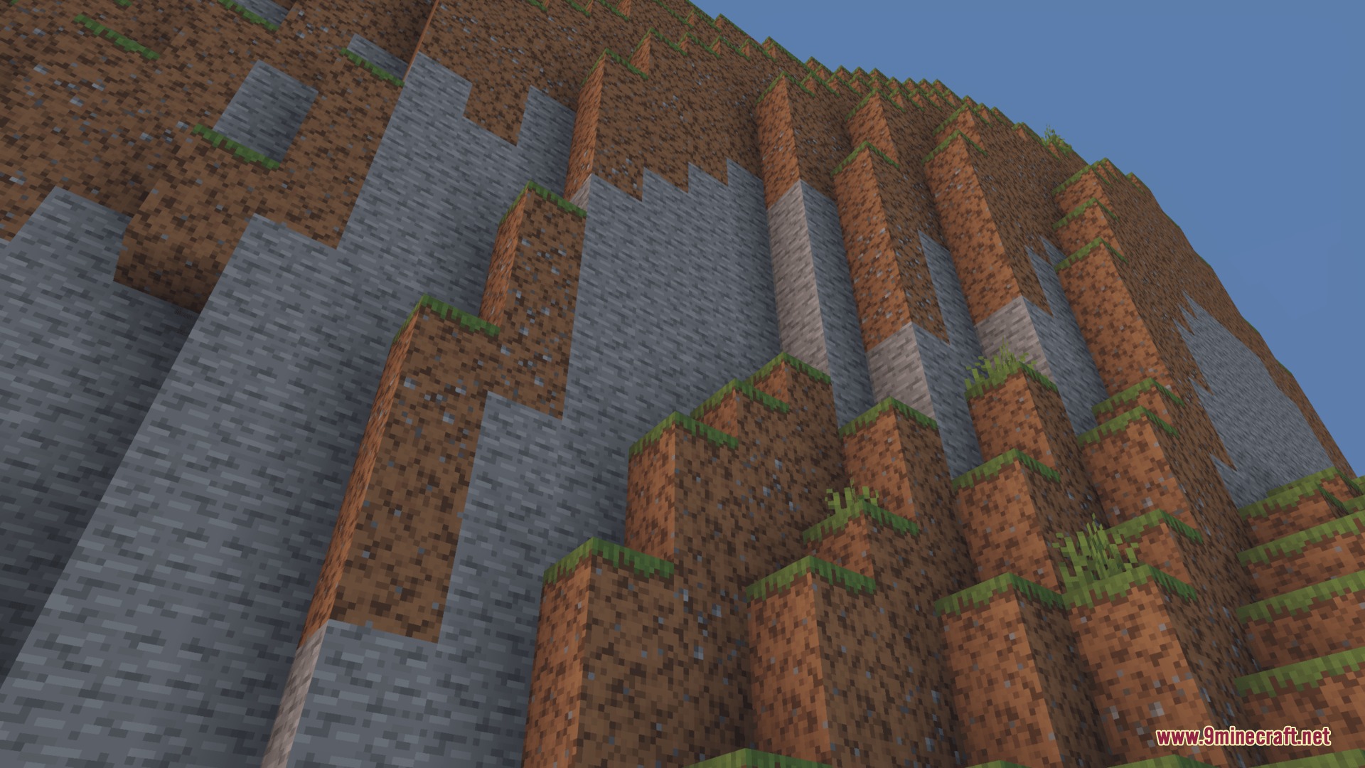 Dungeons Stone Resource Pack Screenshot 1 A steep cliffside made of stone and dirt blocks in a Minecraft world