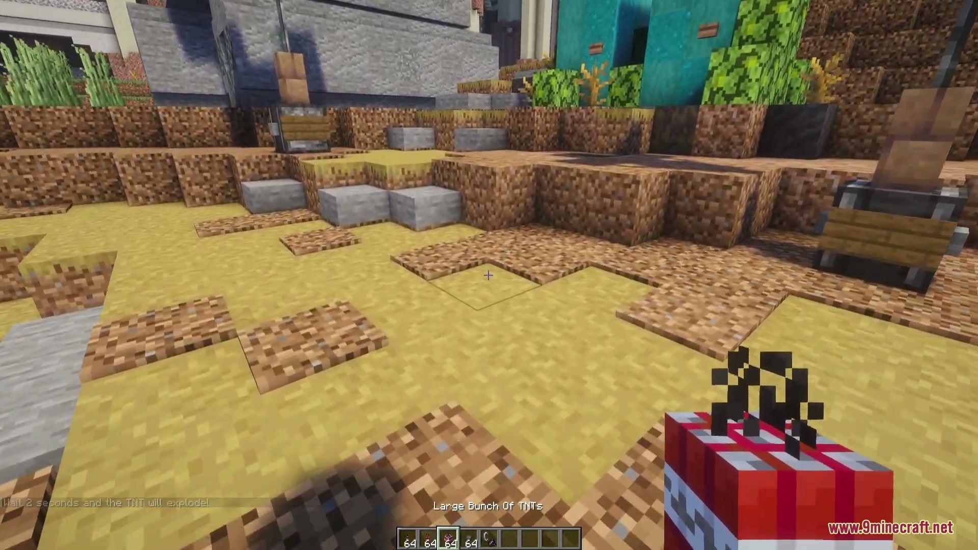 Dynamites Overhaul Mod Screenshot 5 A player holds a bundle of dynamite sticks in a desert area