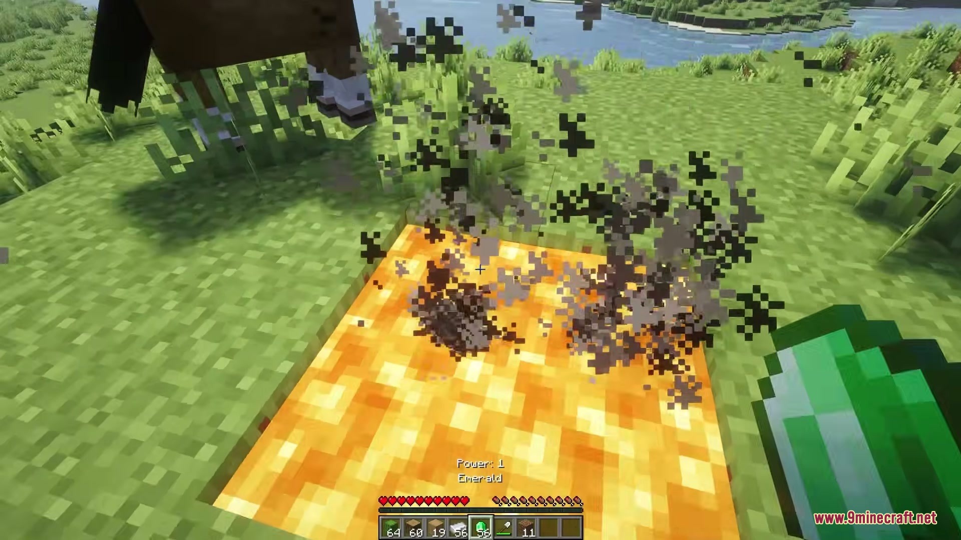 Eating Animations Mod Screenshot 9 Player holding an emerald item near a glowing orange block with smoke particles