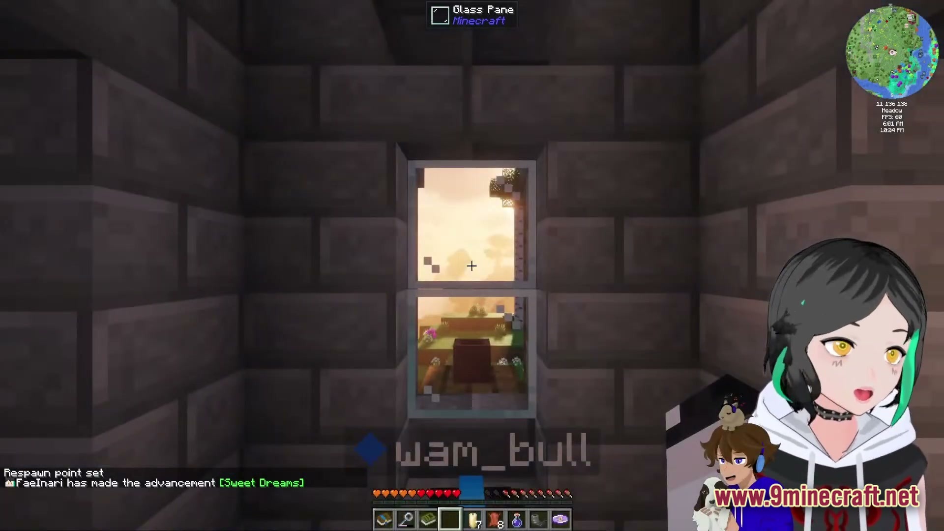 A player looks through a glass pane window inside a stone brick structure during sunset