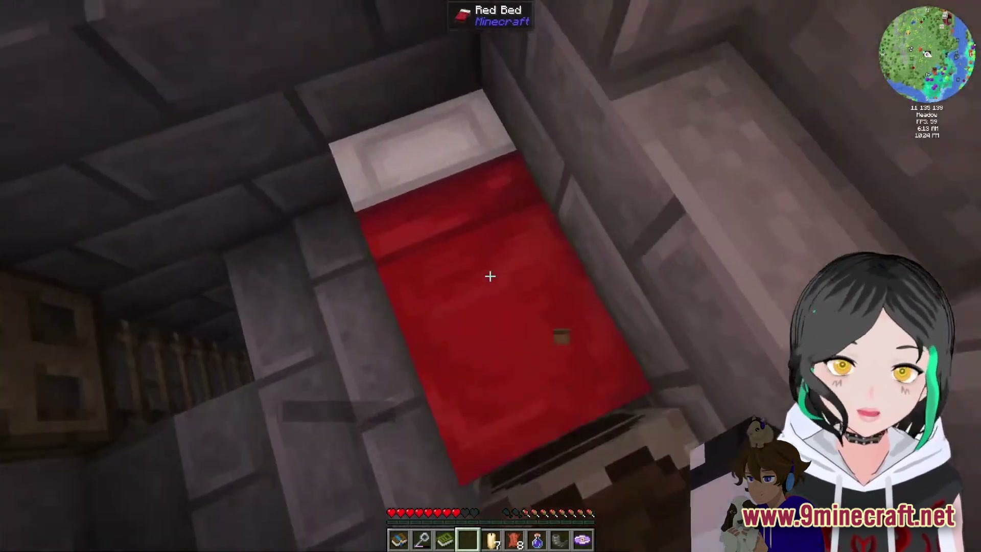 A red bed placed inside a stone brick structure with a VTuber avatar in the corner
