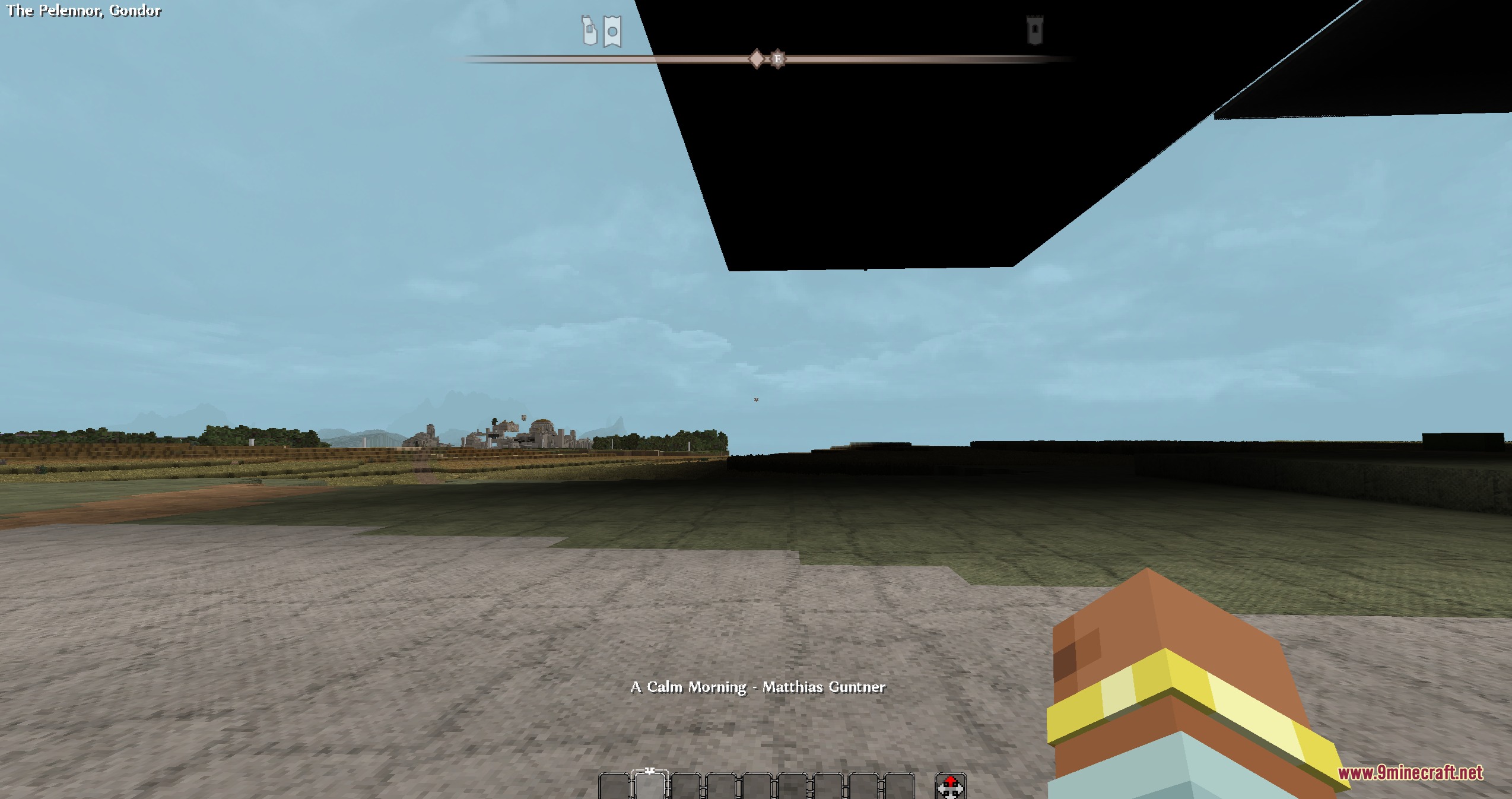 A player explores a flat landscape while music track information is displayed