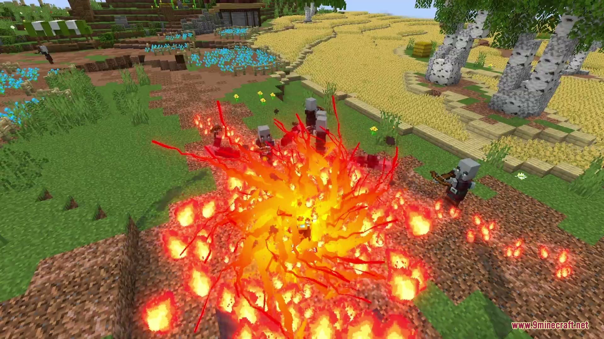 A massive fire explosion engulfs a group of hostile Illagers in a field