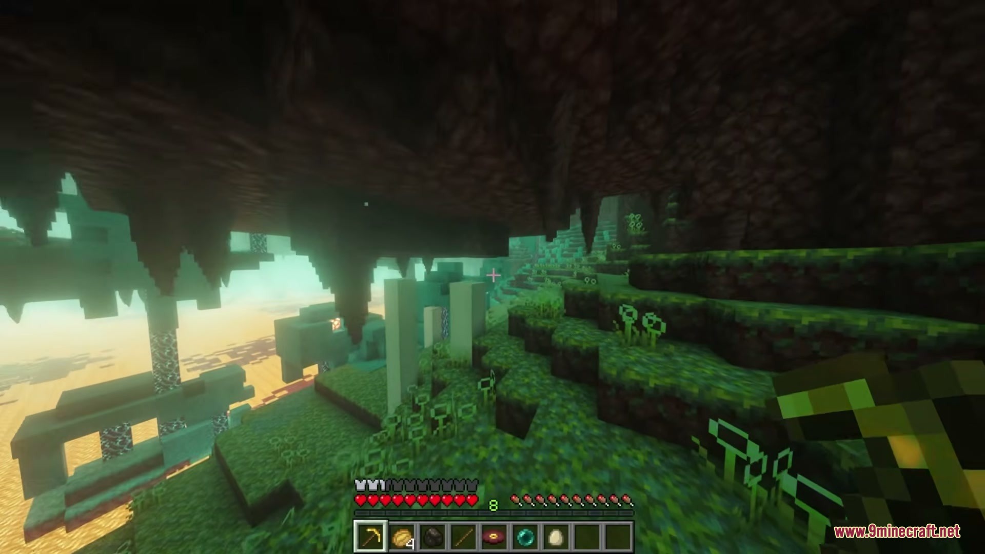 Even Better Nether Mod Screenshot 2 A player stands in a green fungal forest with stalactites hanging from above
