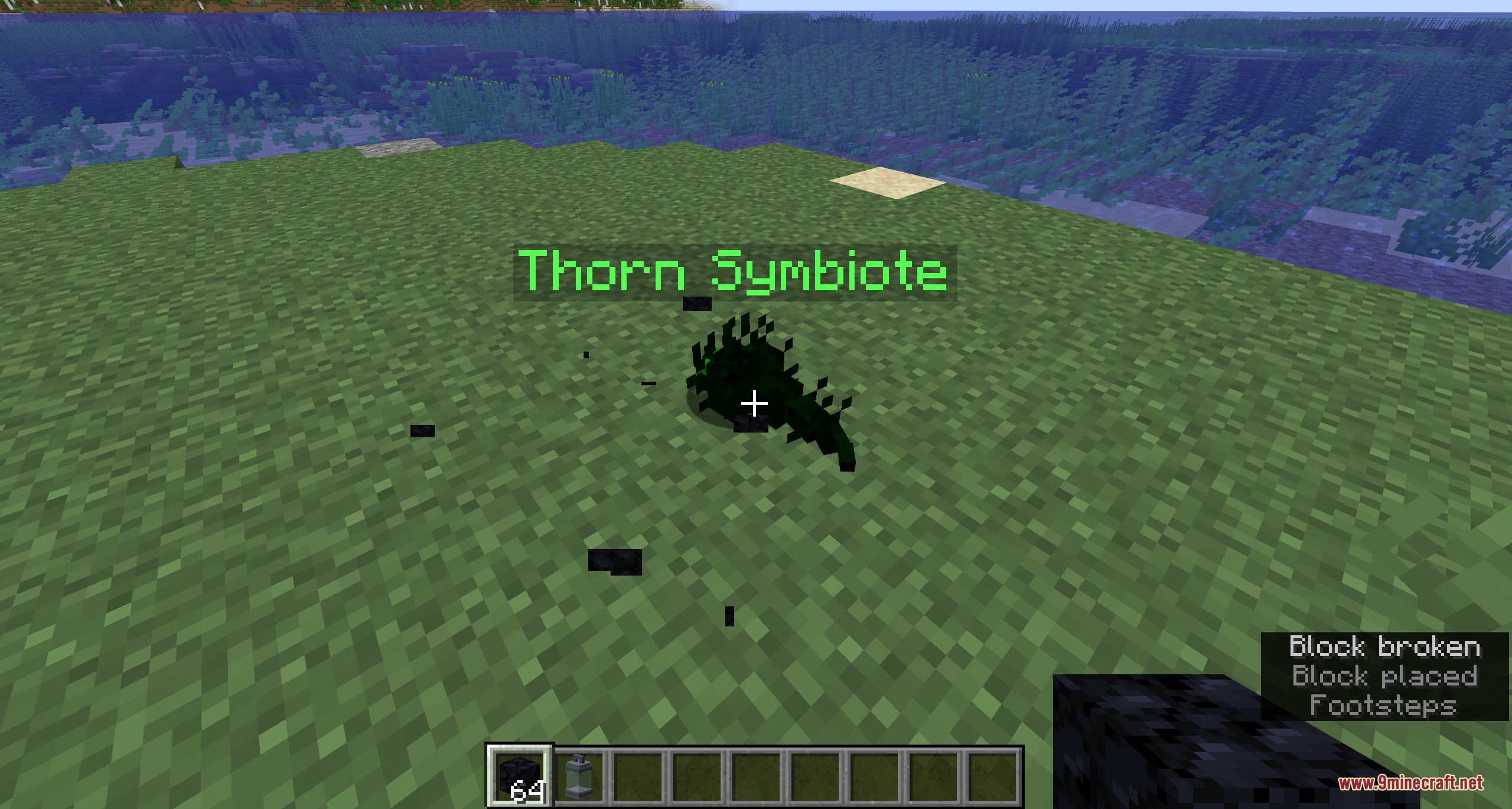 A dark green Thorn Symbiote creature moving across a grassy Minecraft field