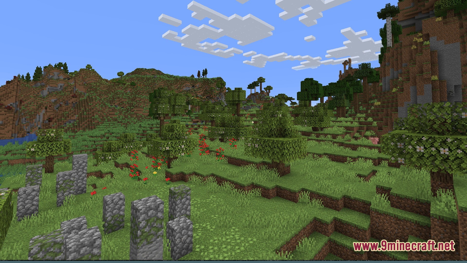 FF's Terra Forge Modpack Screenshot 8 Mossy cobblestone ruins stand in a grassy meadow surrounded by flowering trees and rolling hills