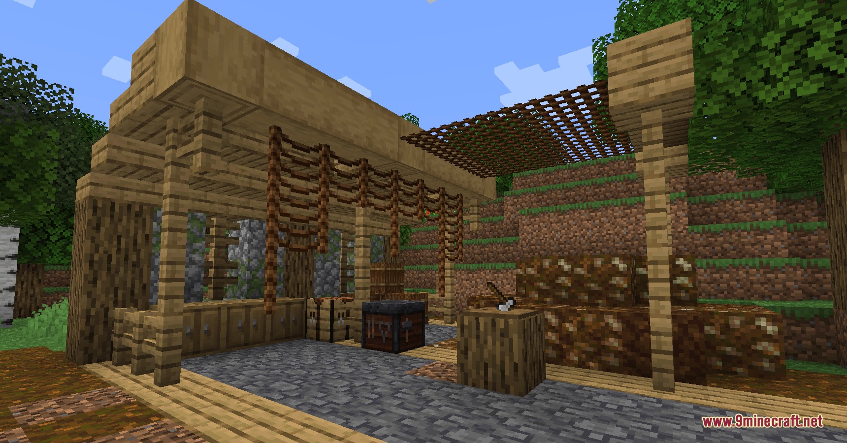 A rustic outdoor workshop featuring a cutting board and piles of rich soil