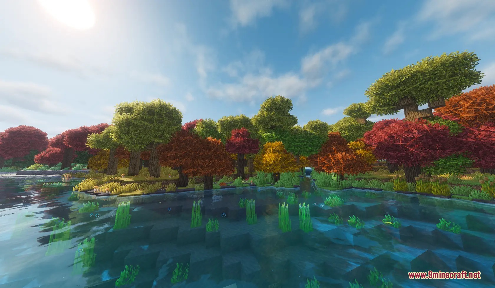 Folium Frond Expansion Mod Screenshot 5 A serene lake surrounded by vibrant bushy trees with autumn leaf colors