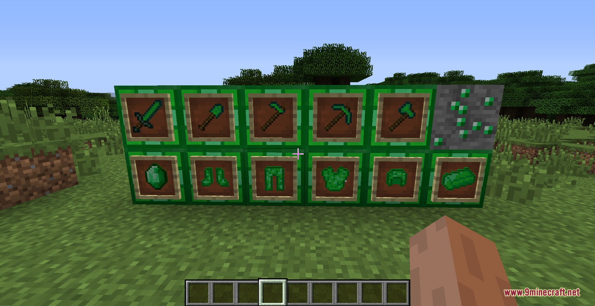 Emerald tools and armor sets displayed in item frames on emerald blocks