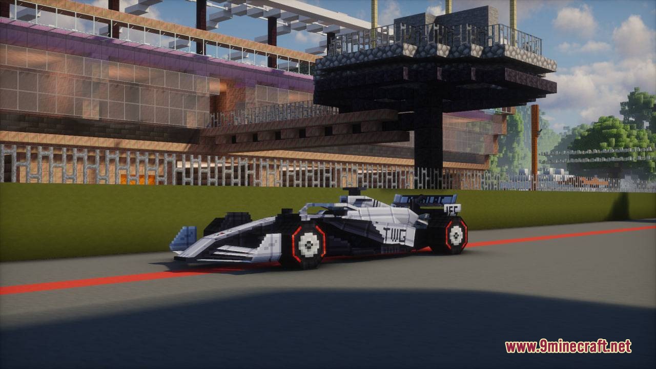 Formula MC Mod Screenshot 2 White and black formula racing car parked on a track near modern buildings