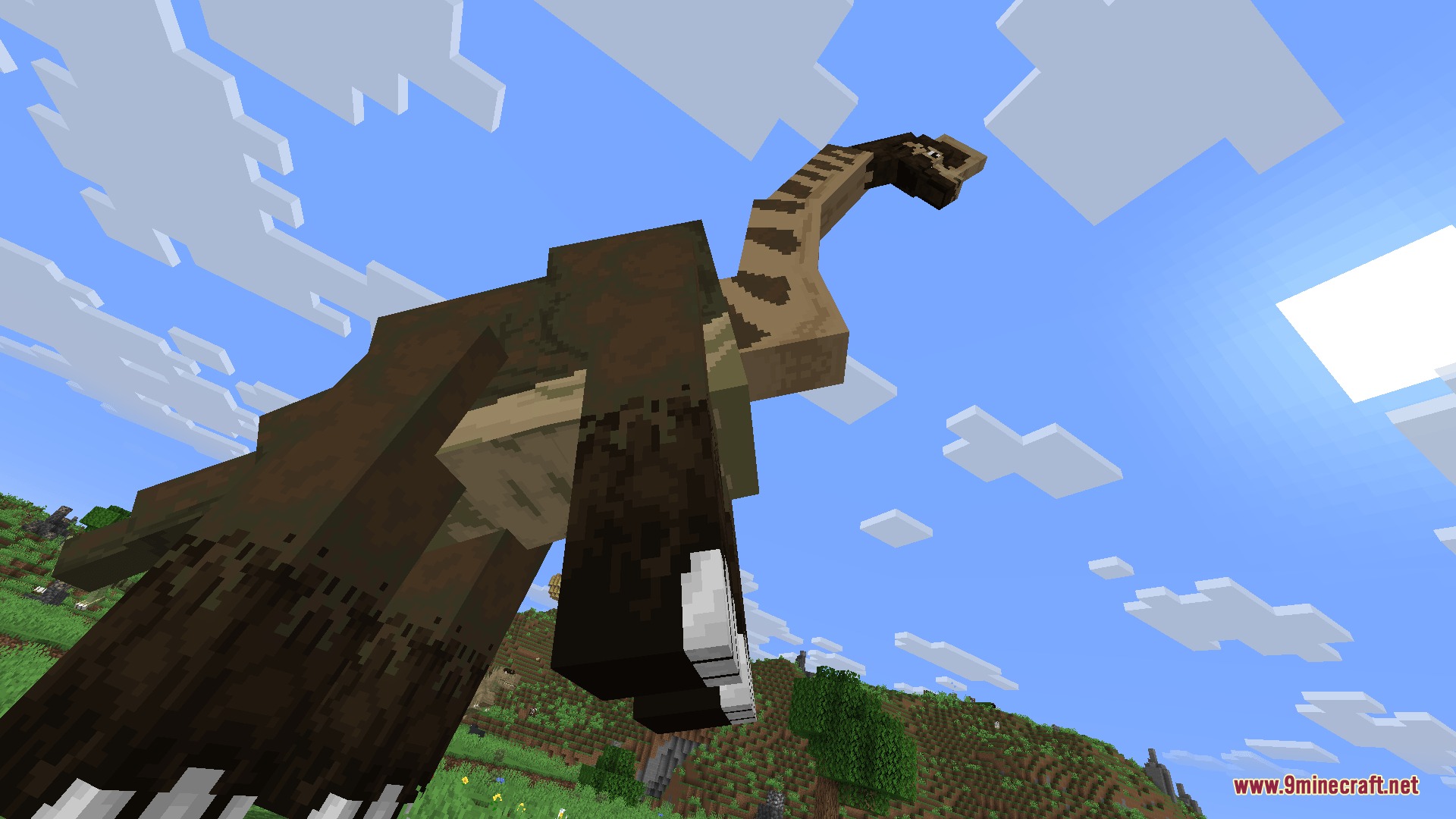 Fossils&Archeology Origins Mod Screenshot 2 A massive sauropod dinosaur towers over the player under a blue sky