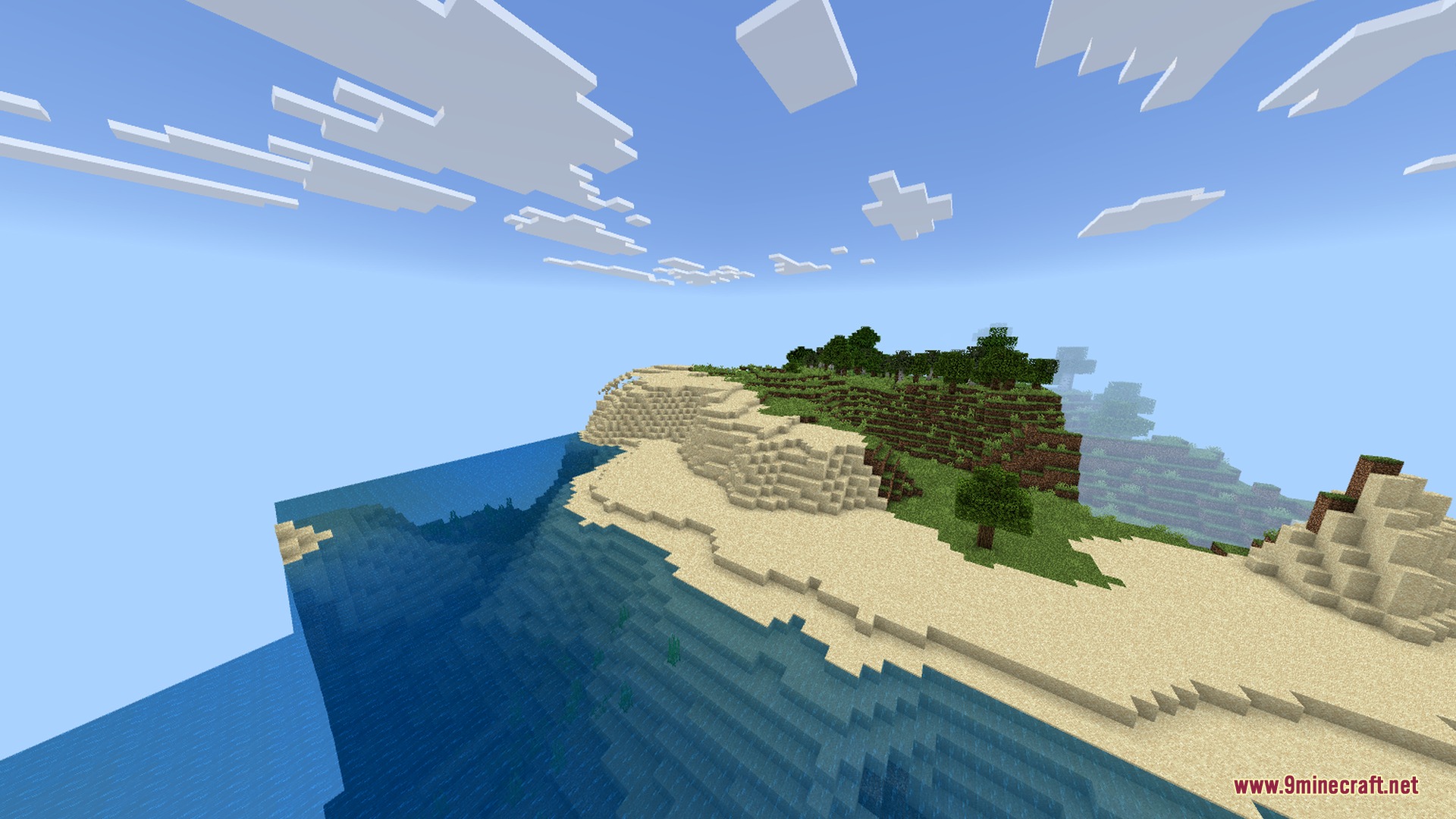 Bright coastal landscape with clear blue water and a sandy beach