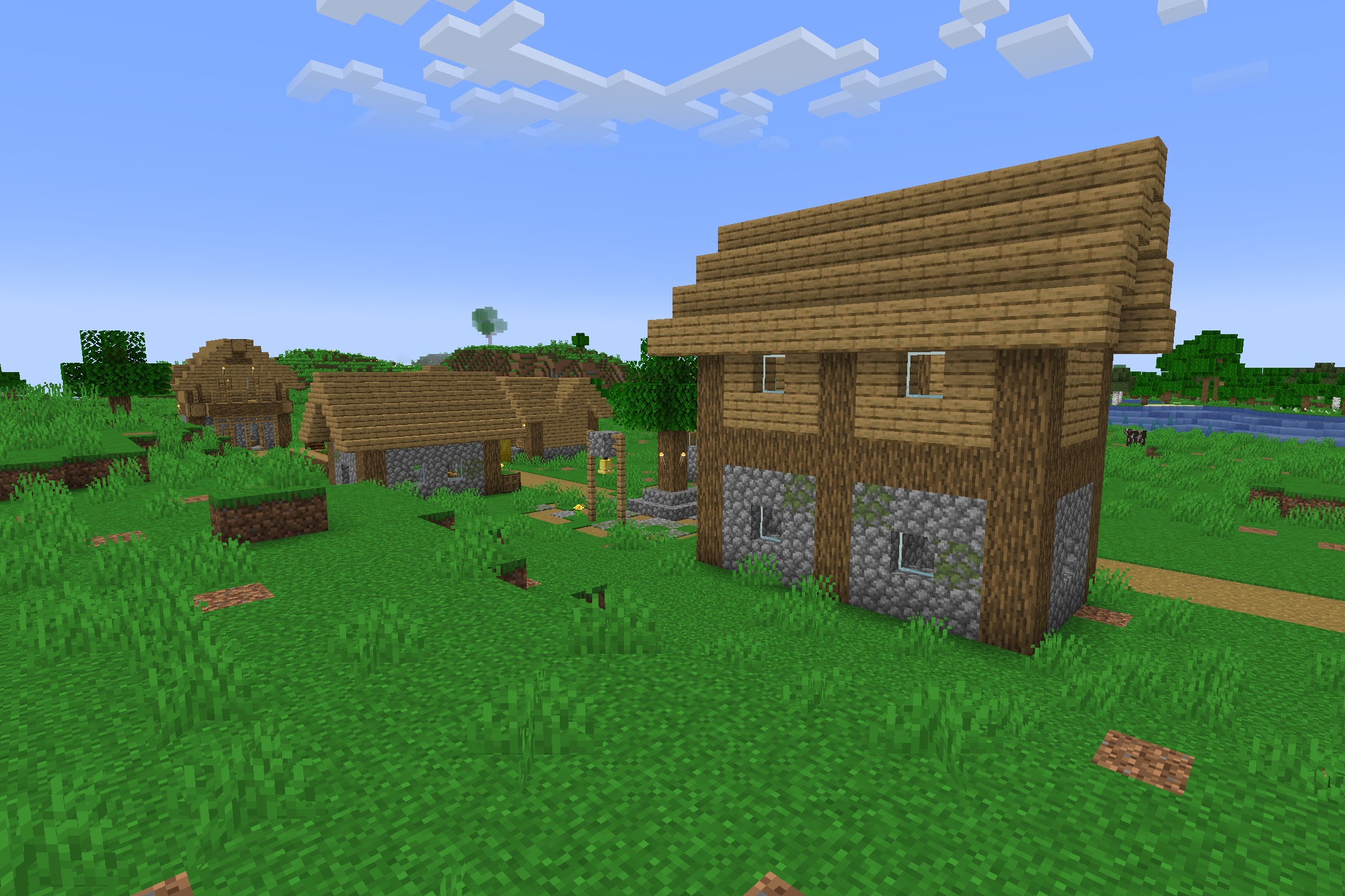 Fps Boost Pack by Verse Playz XD Resource Pack Screenshot 3 A small Minecraft village with wooden houses on a green grassy field