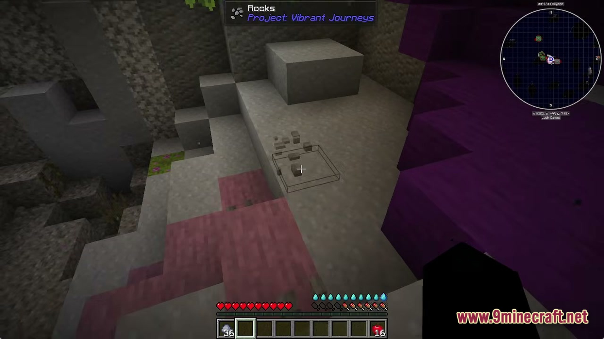 A player looks at small rocks on the ground within a cave in Fractured Opolis