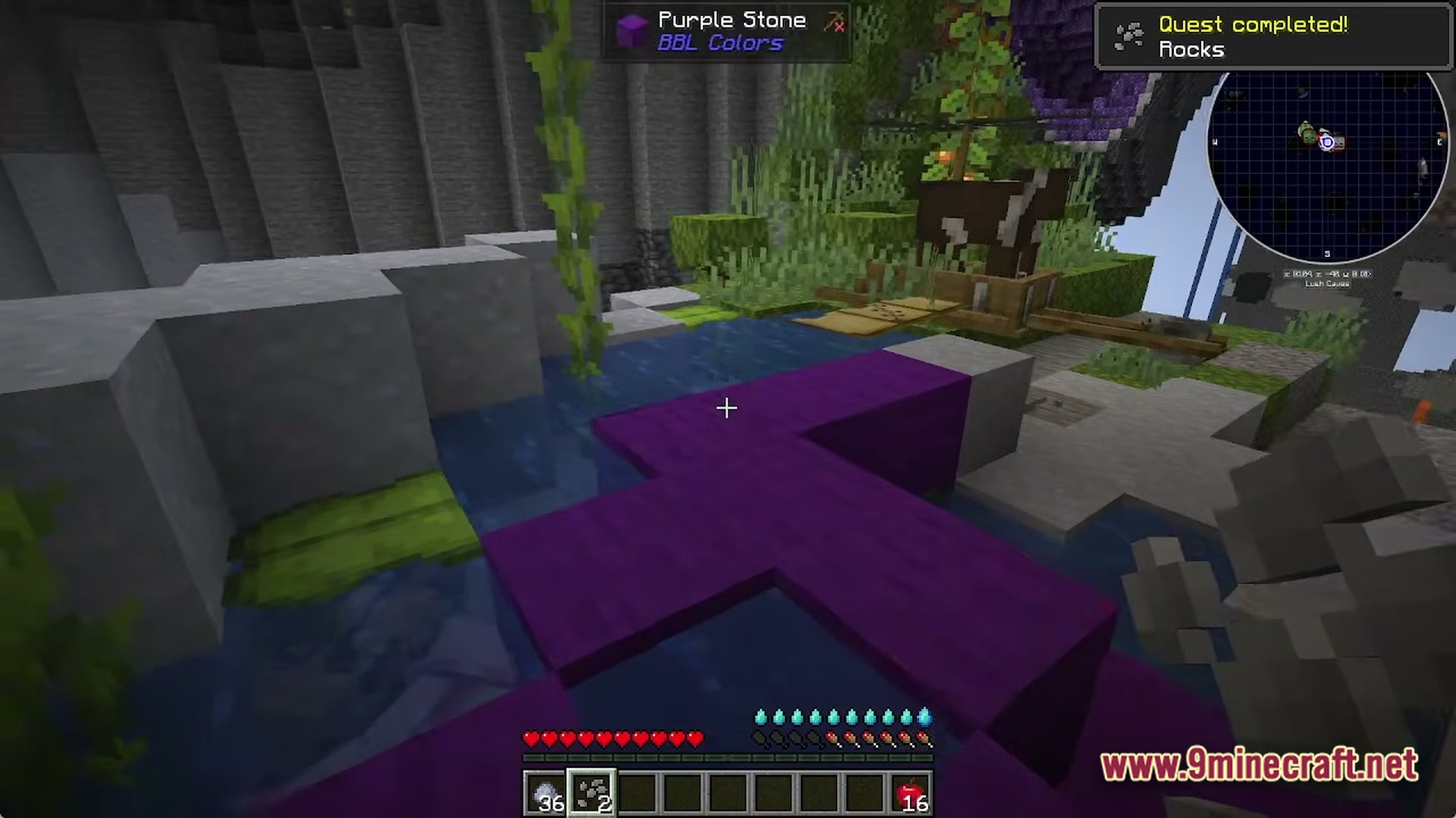 Purple stone blocks placed in a lush cave environment with a cow and quest completion notification