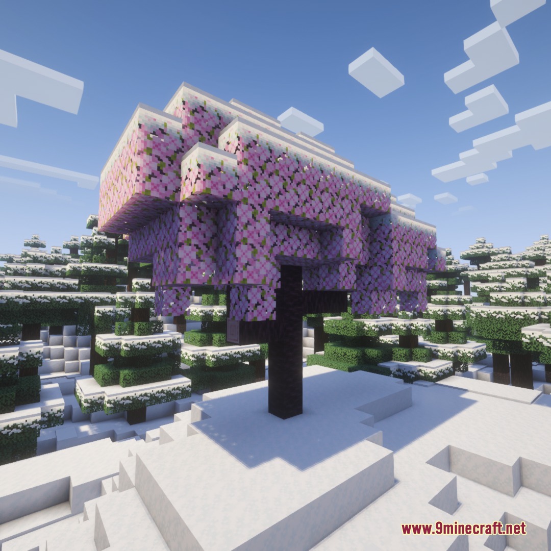 Frost Glazed Canopies Mod Screenshot 5 Pink cherry blossom tree with snow on its leaves in a winter biome