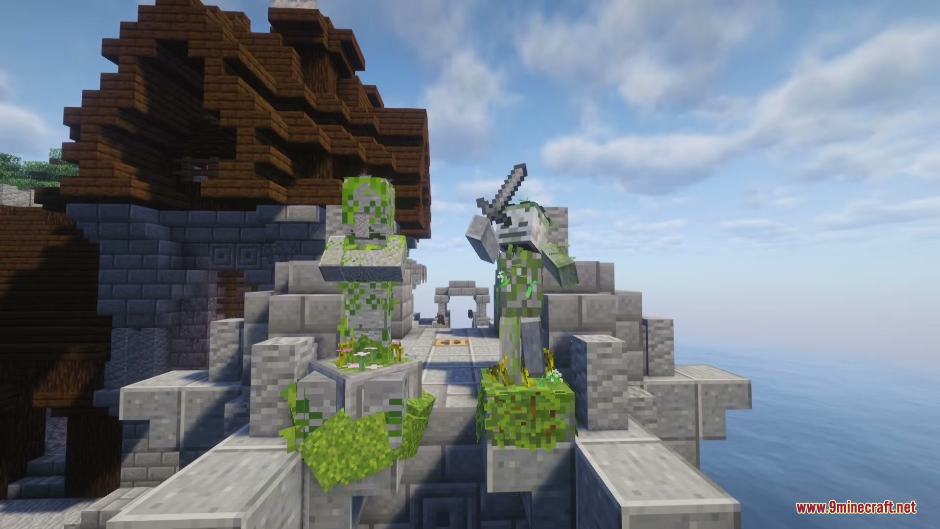 Mossy stone statues of a villager and a skeleton on a stone bridge