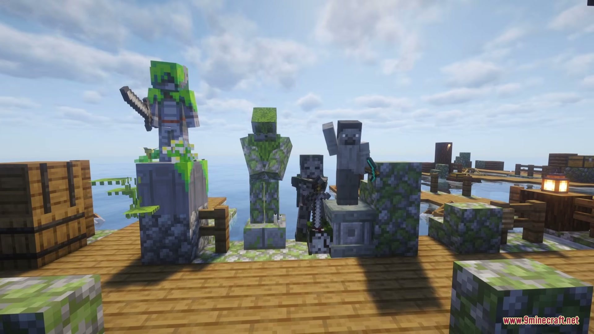 Various mossy stone statues standing on a wooden dock near the water