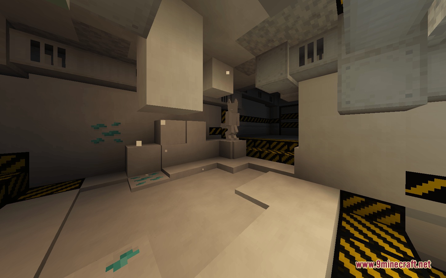 A white industrial facility room featuring a statue and hazard floor stripes