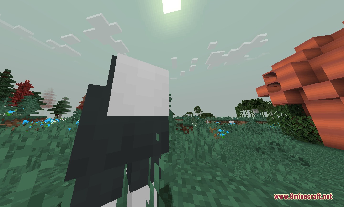 A player character with a white mask stands in a flowery field