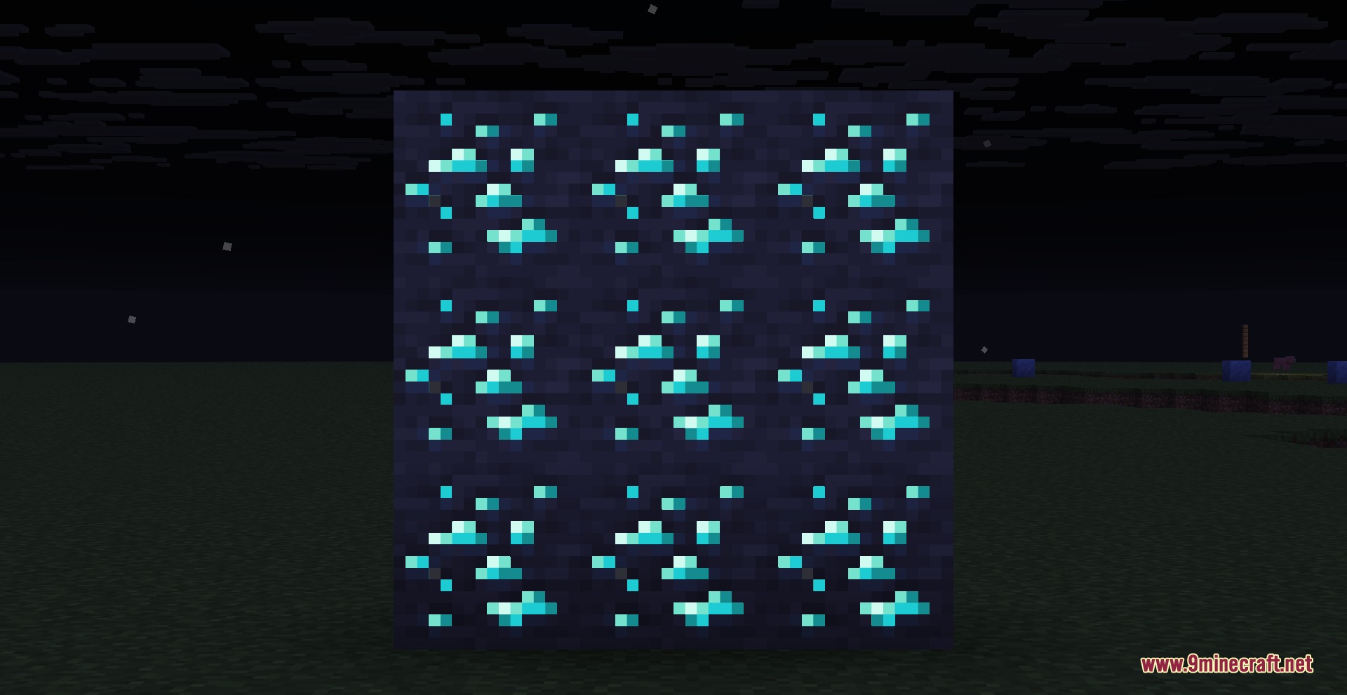 Nine diamond ore blocks with glowing blue textures in a dark setting