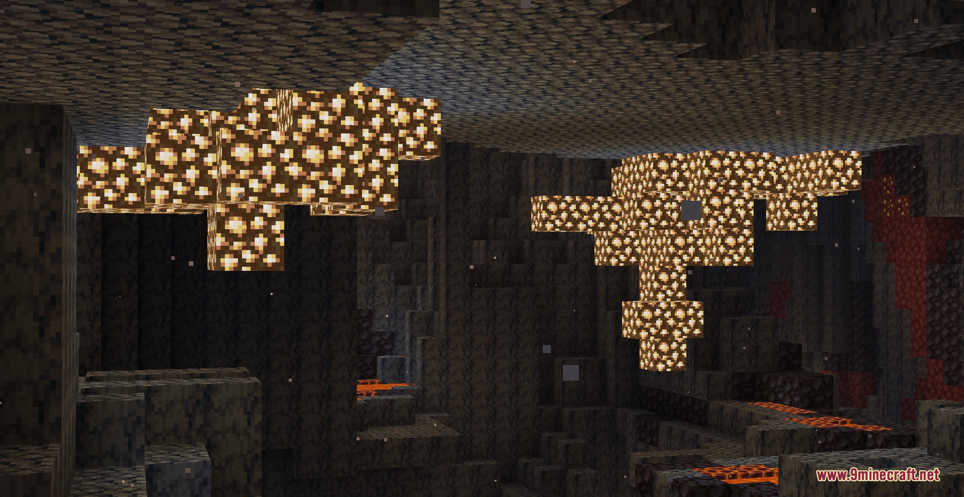 Brightly glowing clusters of glowstone blocks hanging from a cave ceiling