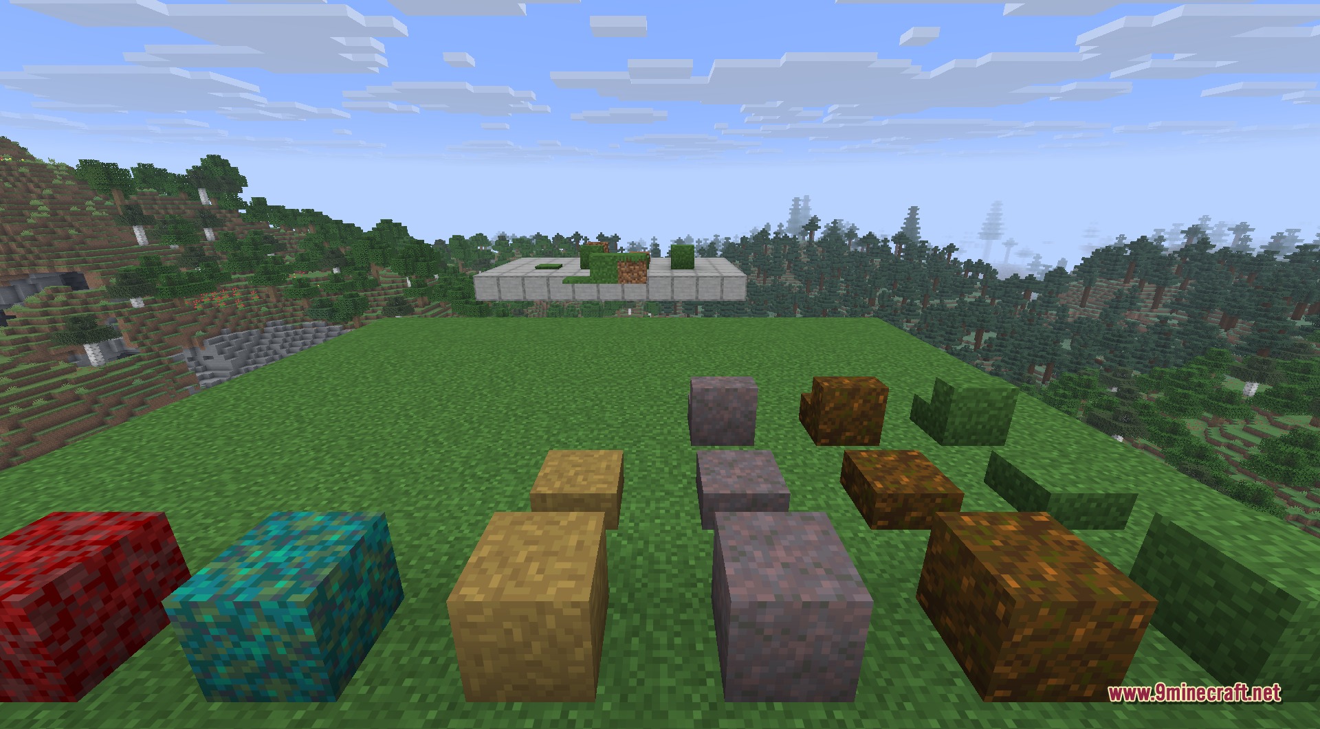 Various colorful grass blocks slabs and stairs displayed on a flat green field