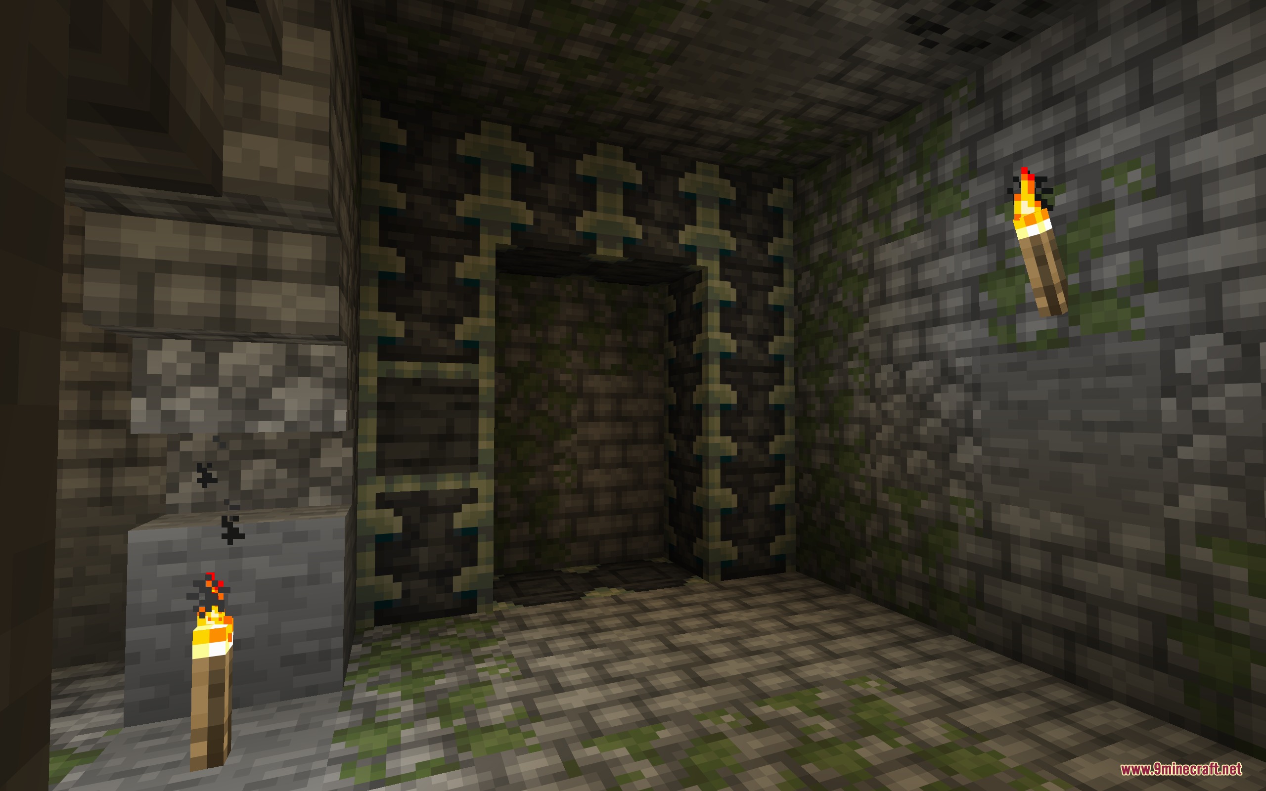 Torches light up a mossy stone brick room with a unique decorated entrance